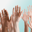 hands raised against blue background