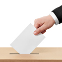 hand dropping ballot into box