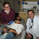 Dr. Judson Werner, a dental hygienist, and a young patient in a dental chair